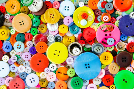 Colorful mixed sewing buttons background. Top view