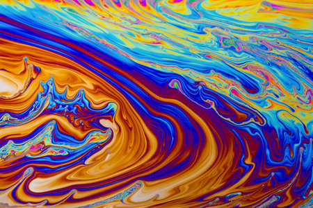 Rainbow colors. Psychedelic multi colored patterns background. Photo macro shot of soap bubblesの写真素材