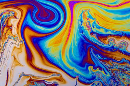 Rainbow colors. Psychedelic multi colored patterns background. Photo macro shot of soap bubblesの写真素材