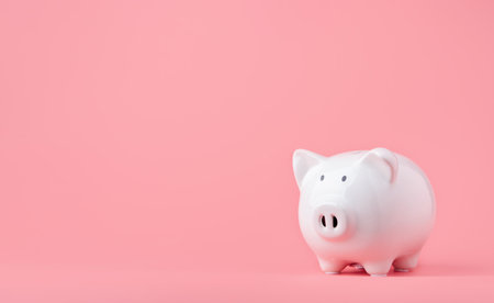 Money saving and investment concept. Piggy bank on pink background with copy spaceの写真素材