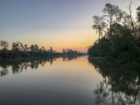 venice canal with fog and reflection at sunrise in summerの写真素材