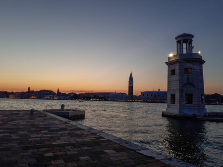 sunset in venice with a lighthouse onの写真素材