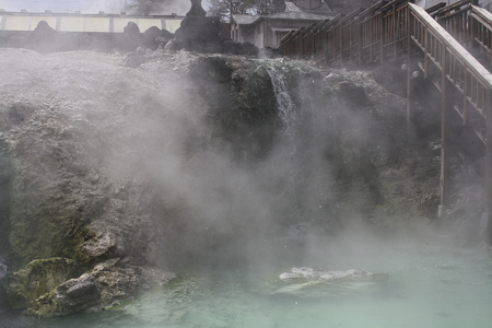 a water mill on the waterfall with fogの写真素材