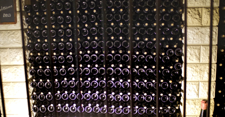 a wine cellar in a cave with bottles in the wall
