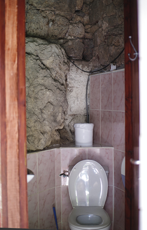 a toilet in a stone cave for touristsの写真素材