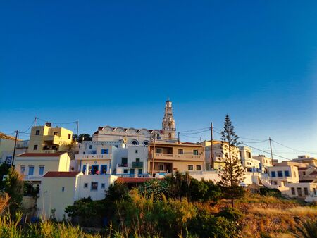 sunset over a village at the bay in greece at summer