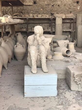 a petrified man is sittiing on a boxの写真素材