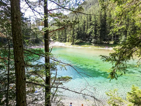 a wonderul green lake with mountains behind at summer