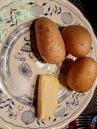 raw potatoes on a plate for dinnerの写真素材