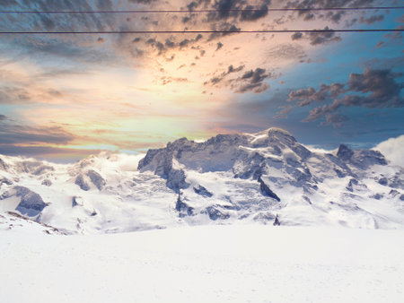 Beautiful winter landscape with snowy mountains and blue sky in the backgroundの写真素材