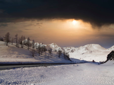Snowy mountain road at sunset, Carpathian Mountains, Ukraineの写真素材