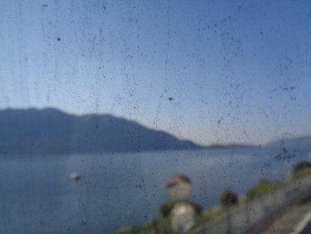 View of Lake Garda through the wet glass of a car.の写真素材