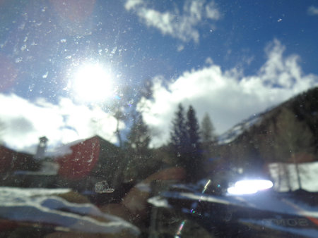 View from inside the car on the snow-covered mountains and blue sky.の写真素材