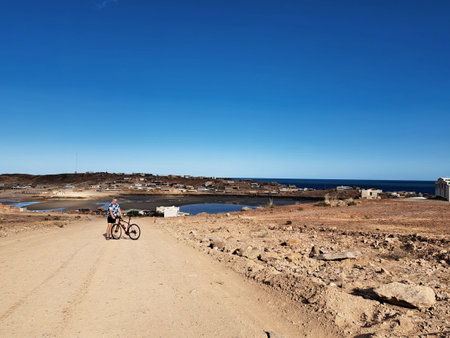 Mother and son cycling on the beach in Lanzarote, Canary Islands, Spainの写真素材