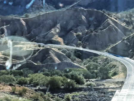 View of the highway in the mountains from the car's side.の写真素材