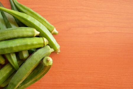 Okra, Ladyâ€™s finger, Gombo, Gumbo, Bendee, Quimbamto on the old wooden