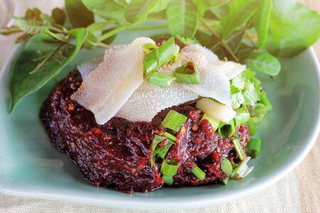 Spicy raw minced Meat mix with cow's blood. Food in Thai northern style (Larp dip). Eaten together with entrails and fresh vegetables.selective focus.の写真素材