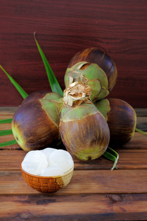 Close up, Group of Sugar palm,Palmyra palm or Toddy Palm. andj peel fruits are in the bolw.Tropical Healthy Refreshment Fruit on wooden talble background and vintage filter.の写真素材