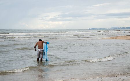 Fisherman in sea action when fishing Thailandの写真素材