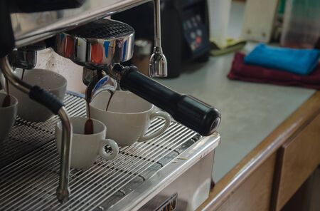 Barista making a cup of coffee soft focus image .