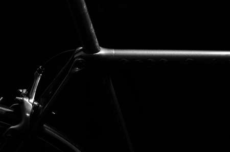 low key black and white silhouette of bicycle black backgroundの写真素材