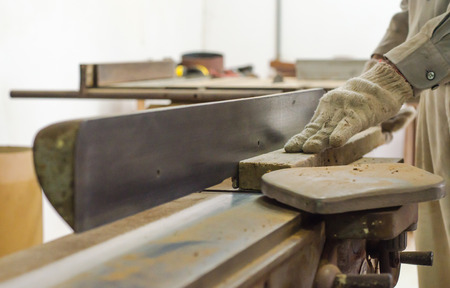The carpenter was working furniture wood in studio
