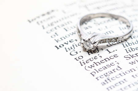 Rings on a book with the word love.の写真素材