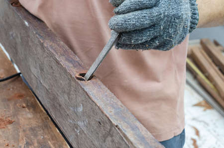 The carpenter was working furniture wood in workshop