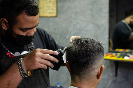 Hairdresser cutting a client's hair soft focus image.の写真素材