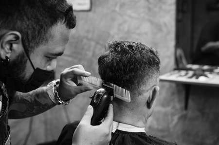 Hairdresser cutting a client's hair soft focus image.の写真素材