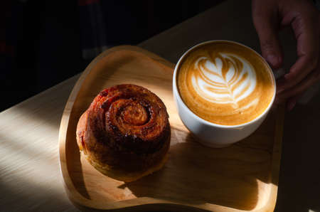 Coffee latte art on wooden tableの写真素材