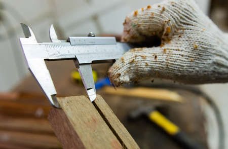 A carpenter working on sawing wood to make furniture in a studio. Soft focusの写真素材
