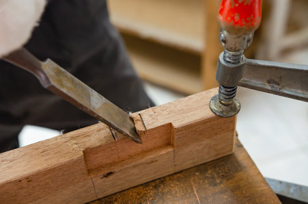 Young man doing woodworking hobby in his workshop, soft focus.の写真素材