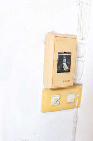 Becker controls the electrical system attached to the white wall.の写真素材