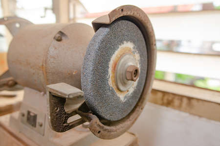 An electric metal grinder that is in the working studio.