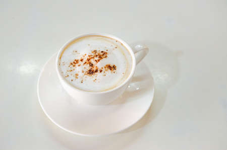 cappuccino coffee on white table soft focus