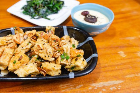 Simple vegetarian dish with eggs, tofu and sauteed vegetables.の写真素材