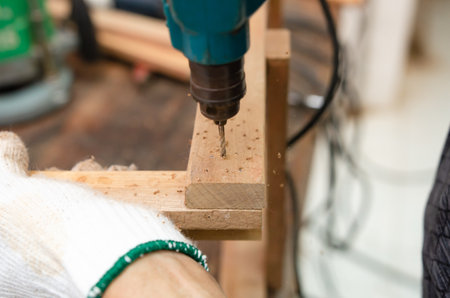 Young man doing woodworking hobby in his workshop, soft focus.の写真素材