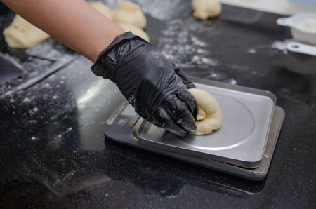 Making bread in the kitchen by a baker