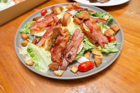 Salad with bacon and cheese and Caesar dressingの写真素材