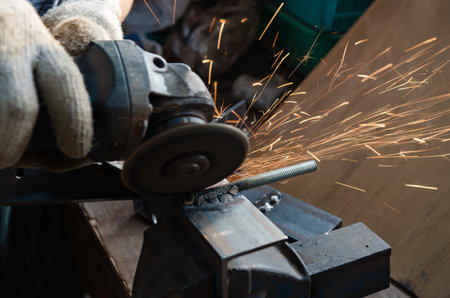 Craftsman working with iron grinding toolsの写真素材