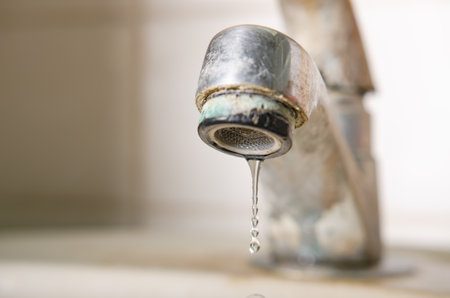 Drops of water from the old faucet.の写真素材