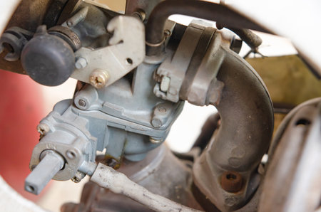Motorcycle carburetor damaged and leaking. Gasoline seeps out. Must be repaired