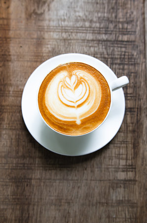 Latte Coffee on a Wooden Table A Warm Morning Momentの写真素材