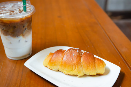 Salt bread and sweet coffee on the table.