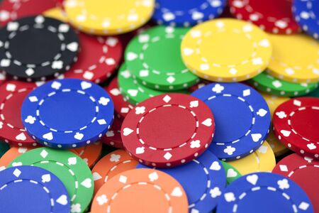 Casino chips, red, yellow, green, orange, blackの写真素材