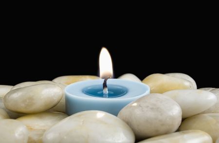 Votive Candle Surrounded by White Pebblesの写真素材