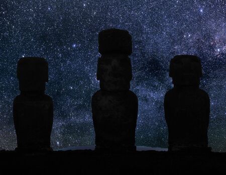 Silhouette of statues from Easter island in the night sky.の写真素材