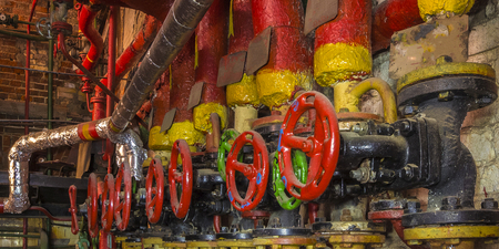 Old pipes and cranes in the industrial shop.の写真素材