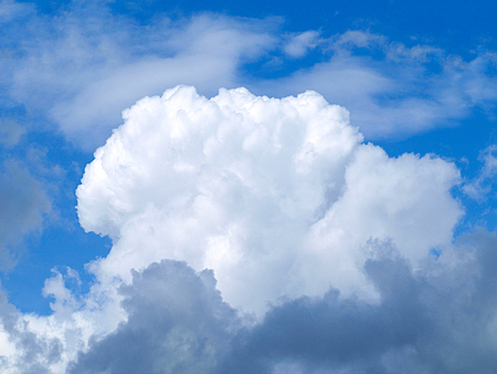 White rain clouds in the blue summer sky.の写真素材